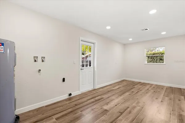a view of empty room with wooden floor