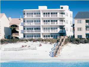 3668 County Road, Unit 101 Santa Rosa Beach, FL 32459 - Photo 2 of 33 a view of a building with a yard covered in snow