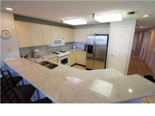 3668 County Road, Unit 101 Santa Rosa Beach, FL 32459 - Photo 11 of 33 a kitchen with stainless steel appliances kitchen island sink refrigerator and stove