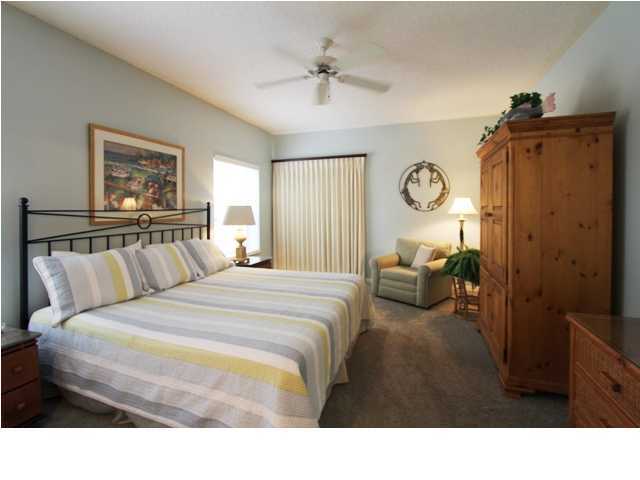 3668 County Road, Unit 101 Santa Rosa Beach, FL 32459 - Photo 18 of 33 a bedroom with a bed and a chandelier