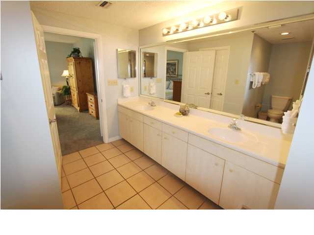 3668 County Road, Unit 101 Santa Rosa Beach, FL 32459 - Photo 20 of 33 a bathroom with a sink a mirror and a shower