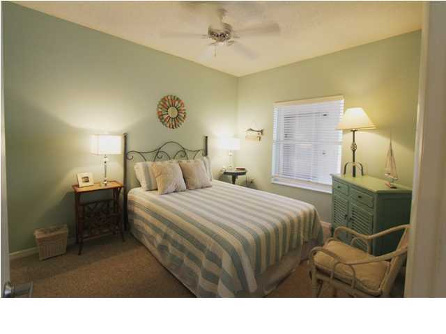 3668 County Road, Unit 101 Santa Rosa Beach, FL 32459 - Photo 23 of 33 a bedroom with a bed and a lamp