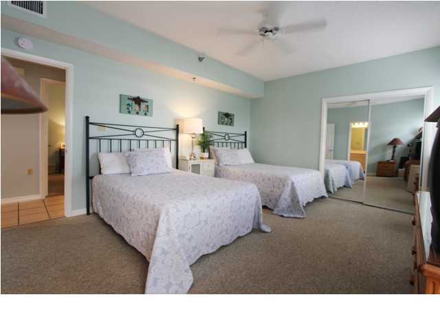3668 County Road, Unit 101 Santa Rosa Beach, FL 32459 - Photo 26 of 33 a living room with two bed and a large mirror
