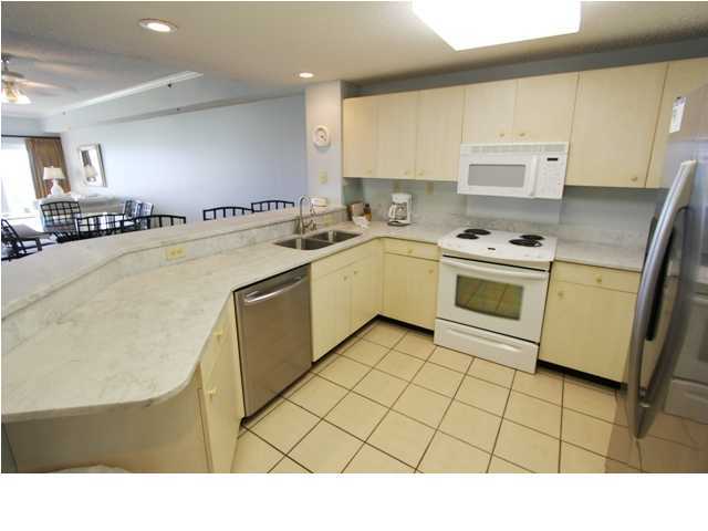 3668 County Road, Unit 101 Santa Rosa Beach, FL 32459 - Photo 8 of 33 a kitchen with appliances cabinets and a sink