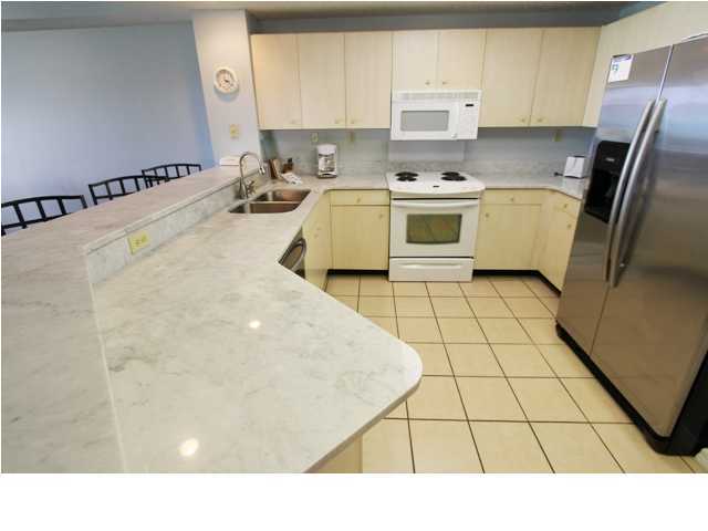 3668 County Road, Unit 101 Santa Rosa Beach, FL 32459 - Photo 9 of 33 a kitchen with a sink a stove and refrigerator