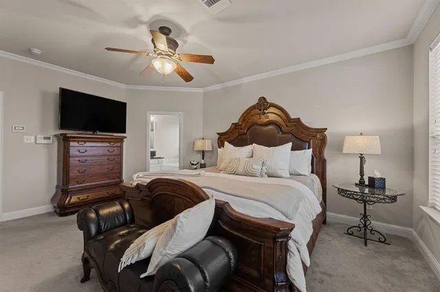 a spacious bedroom with a bed and a flat screen tv