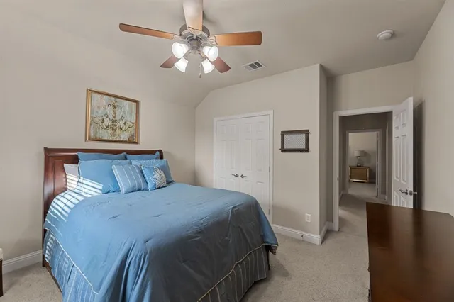 a bedroom with a large bed and a chandelier