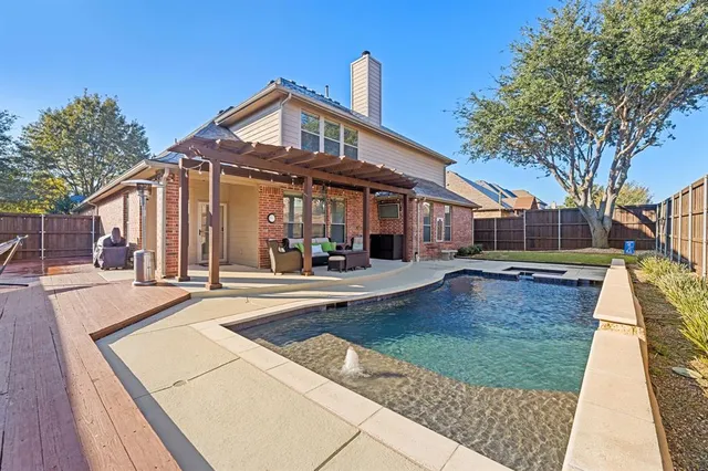 a view of a house with a yard and sitting area