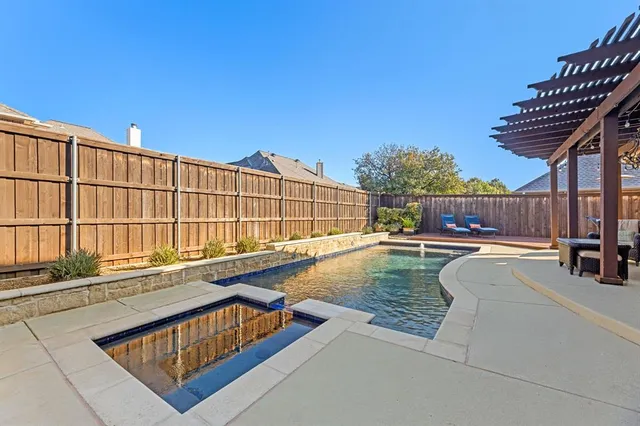 a swimming pool with outdoor seating and yard