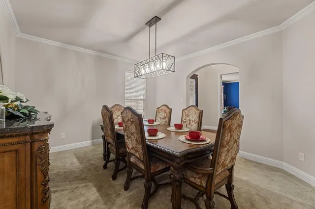 a view of a dining room with furniture and chandelier