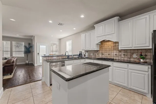 a kitchen with a sink a counter top space and appliances