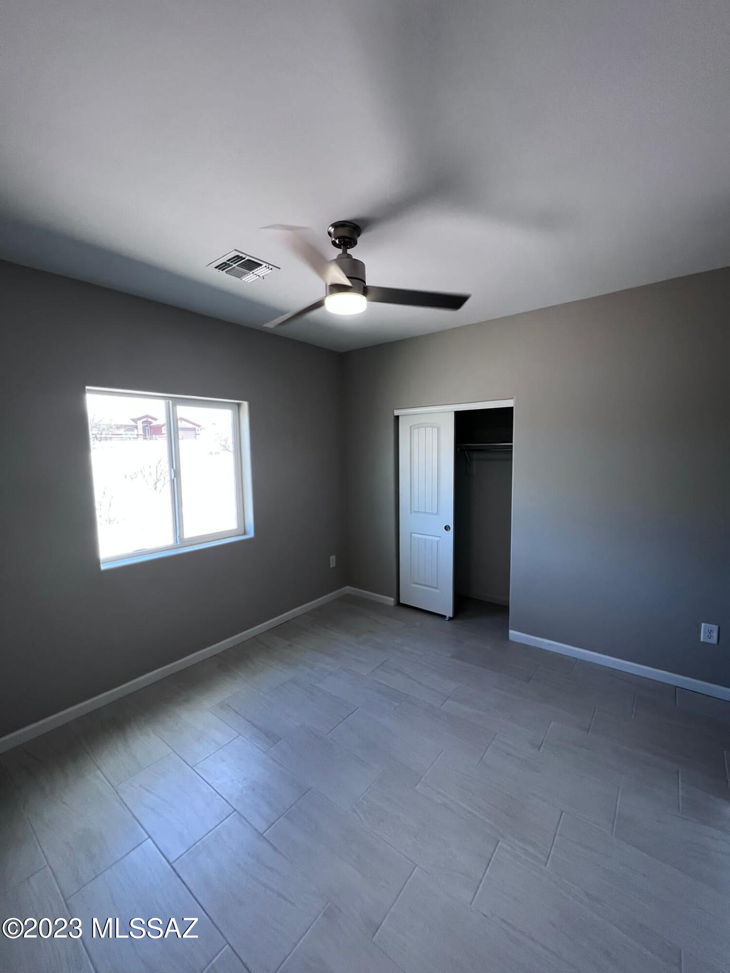 1792 Portugal Court Rio Rico, AZ 85648 - Photo 11 of 14 an empty room with windows and fan