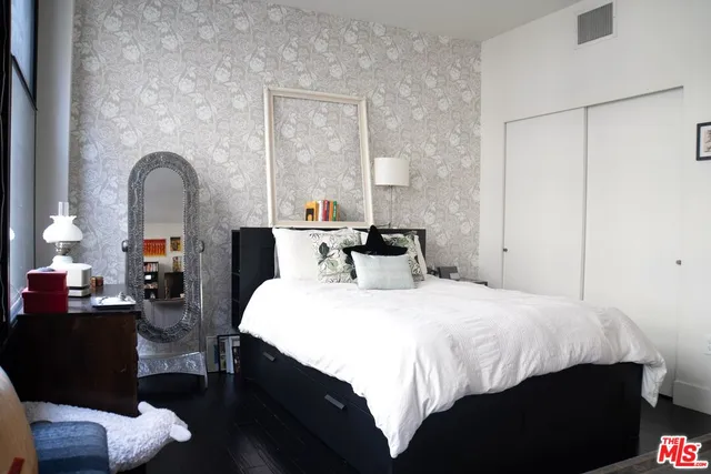 a bedroom with a bed and a dresser