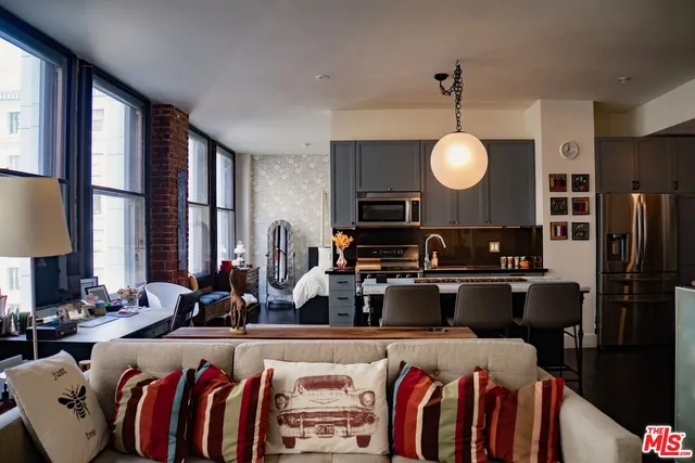 a view of a living room and kitchen area