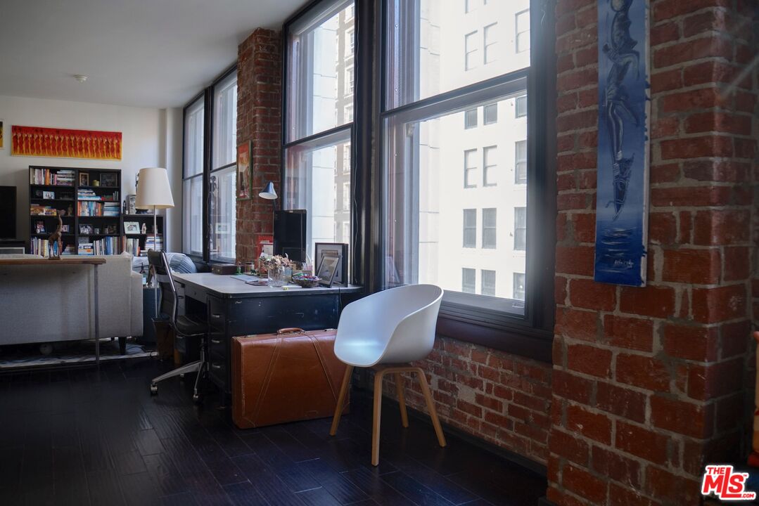 460 South Spring Street, Unit 514 Los Angeles, CA 90013 - Photo 22 of 50 a room with furniture wooden floor and a large window