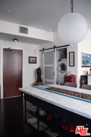 a en suite bathroom with a granite countertop sink and a mirror