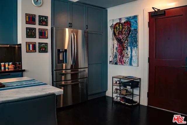 a kitchen with stainless steel appliances a refrigerator and a stove top oven