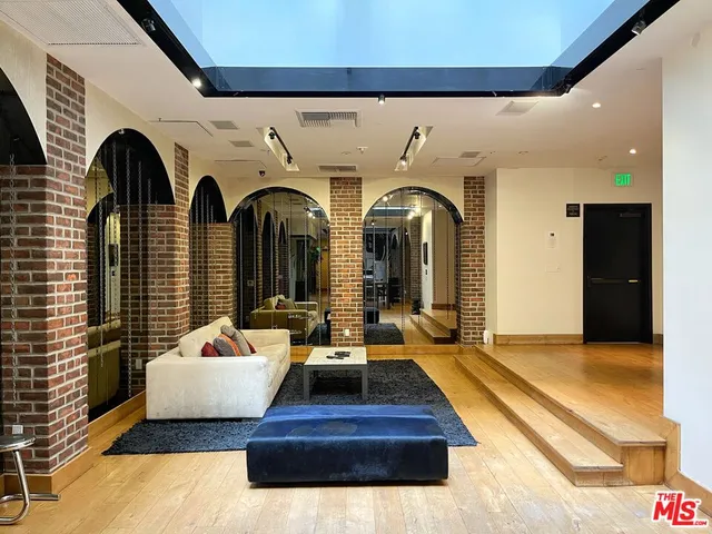 a living room with fireplace furniture and a potted plant