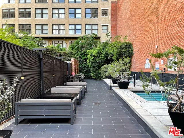 a view of a patio with couches and potted plants