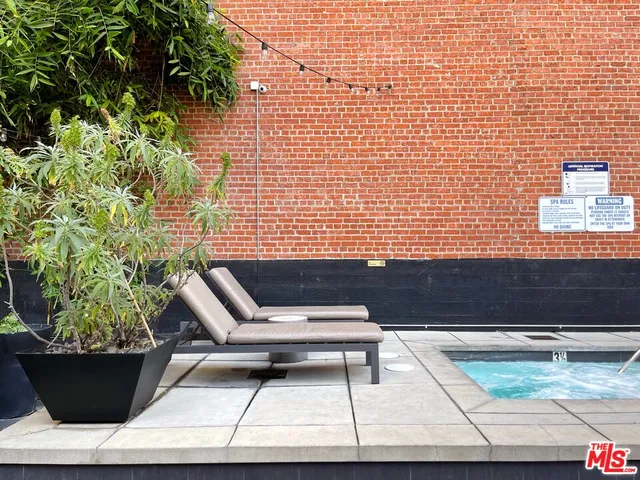 a view of a patio with couches table and chairs and potted plants