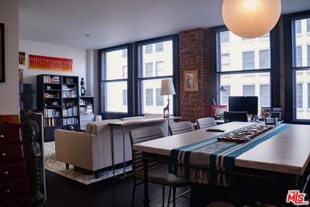a dining room with furniture and a window