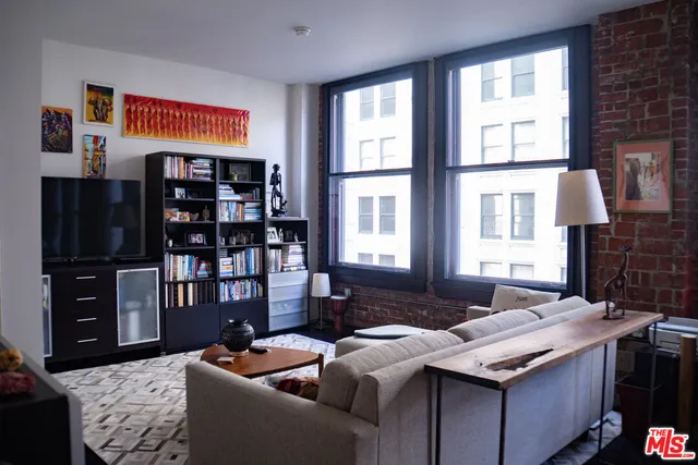 a living room with fireplace furniture and a flat screen tv