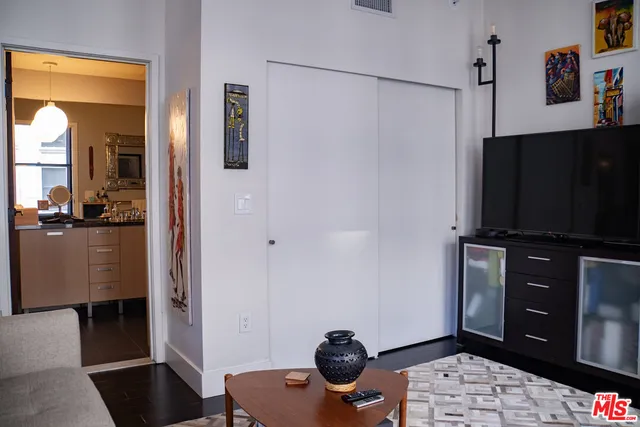 a living room with a bed and a television