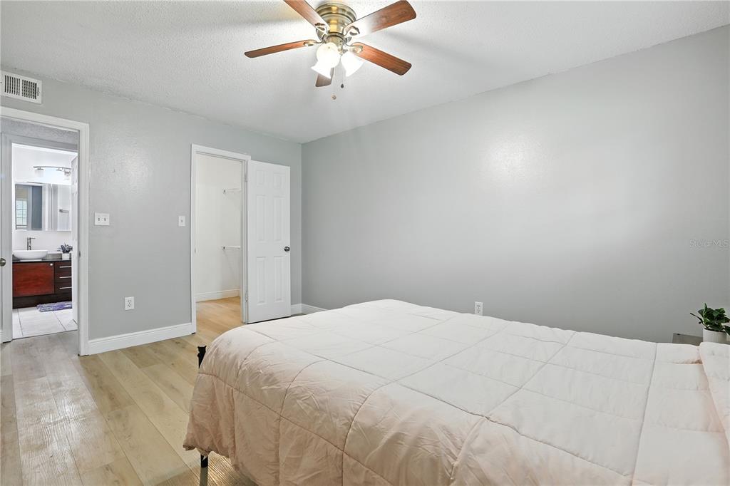 1695 Lee Road, Unit D113 Winter Park, FL 32789 - Photo 11 of 34 a bedroom with a large bed and a chandelier