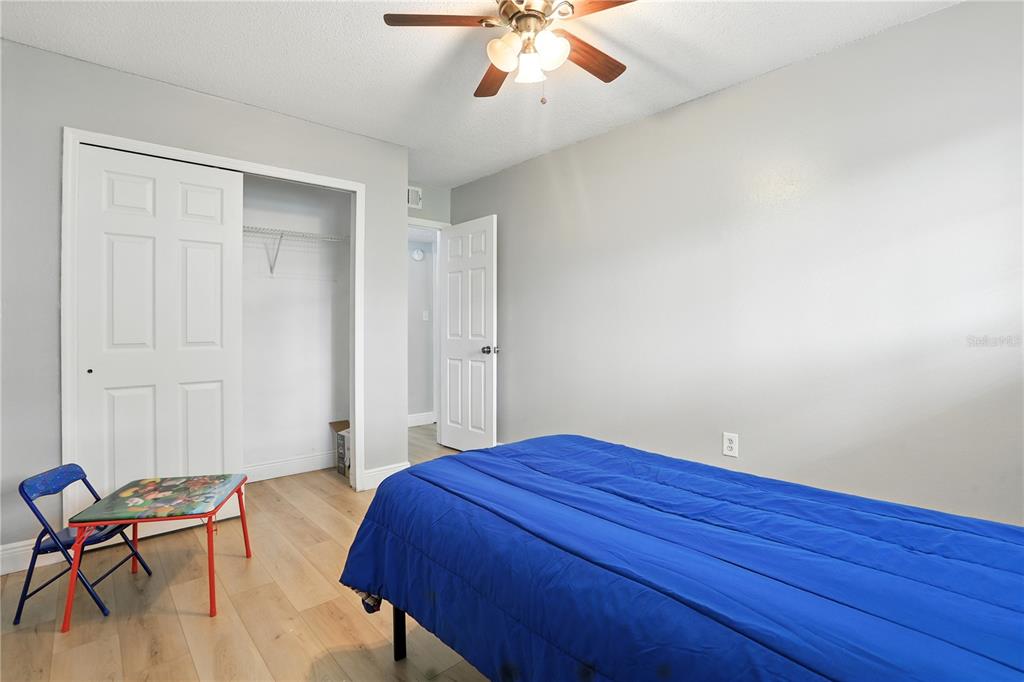 1695 Lee Road, Unit D113 Winter Park, FL 32789 - Photo 14 of 34 a bedroom with a bed and a chair