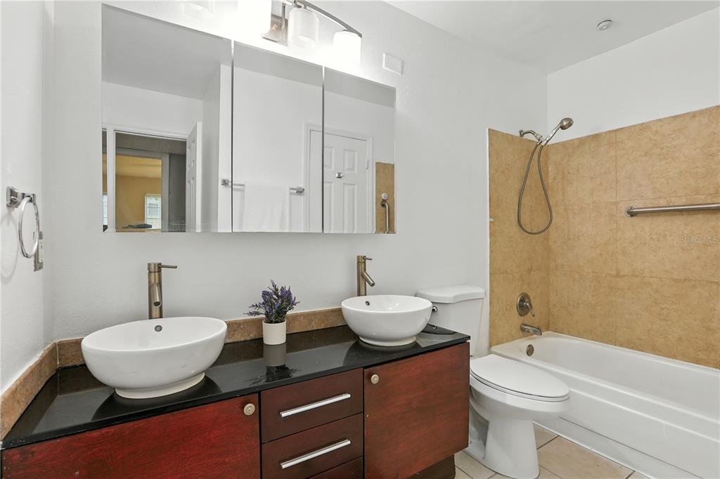 1695 Lee Road, Unit D113 Winter Park, FL 32789 - Photo 15 of 34 a bathroom with a granite countertop sink toilet and shower