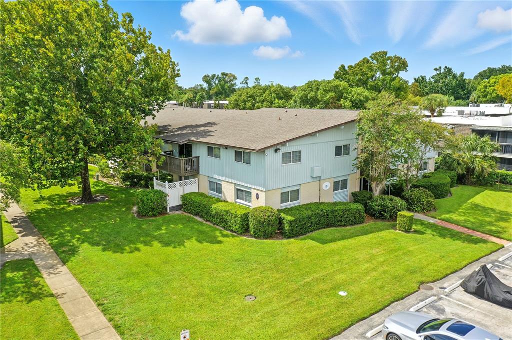 1695 Lee Road, Unit D113 Winter Park, FL 32789 - Photo 33 of 34 a view of a house with a big yard plants and large trees