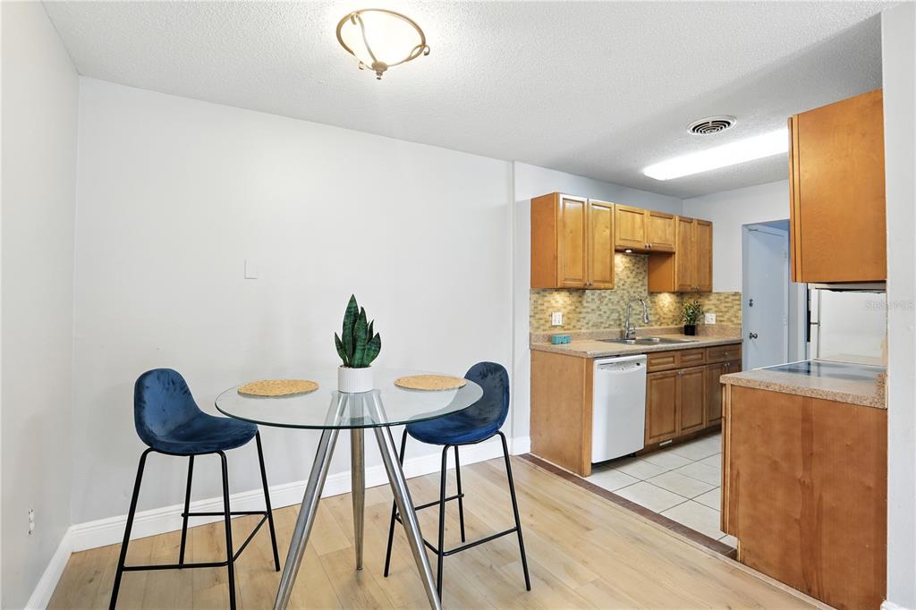 1695 Lee Road, Unit D113 Winter Park, FL 32789 - Photo 5 of 34 a kitchen with stainless steel appliances kitchen island a table and chairs in it