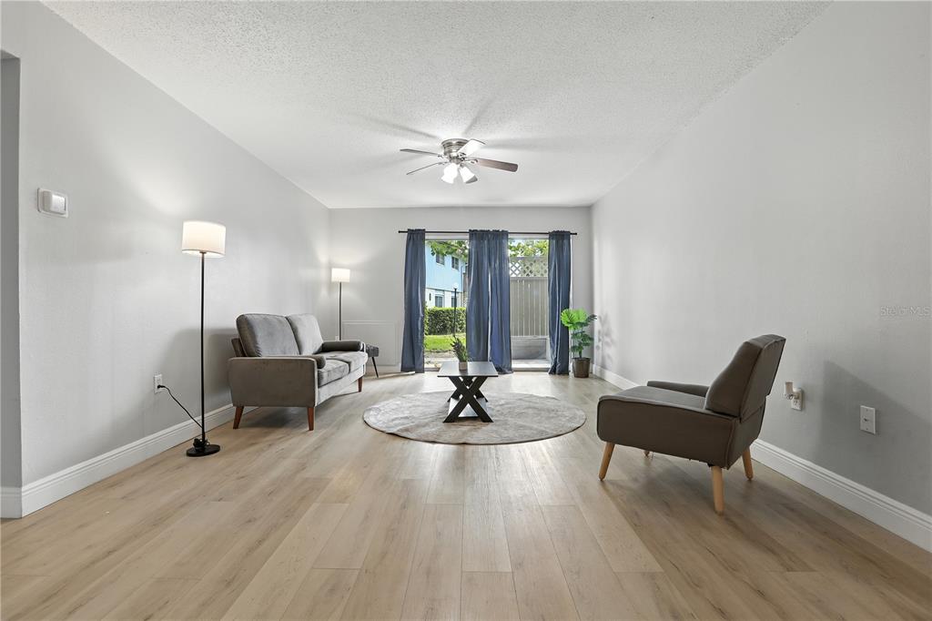 1695 Lee Road, Unit D113 Winter Park, FL 32789 - Photo 7 of 34 a living room with furniture and a potted plant