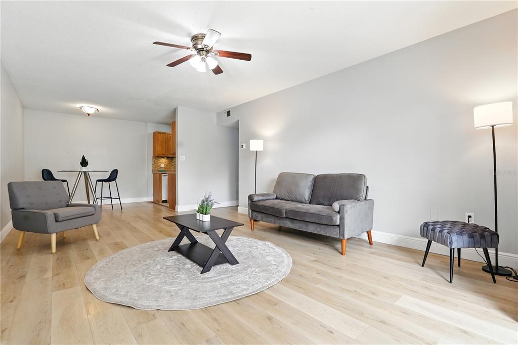 1695 Lee Road, Unit D113 Winter Park, FL 32789 - Photo 9 of 34 a living room with furniture and a chandelier
