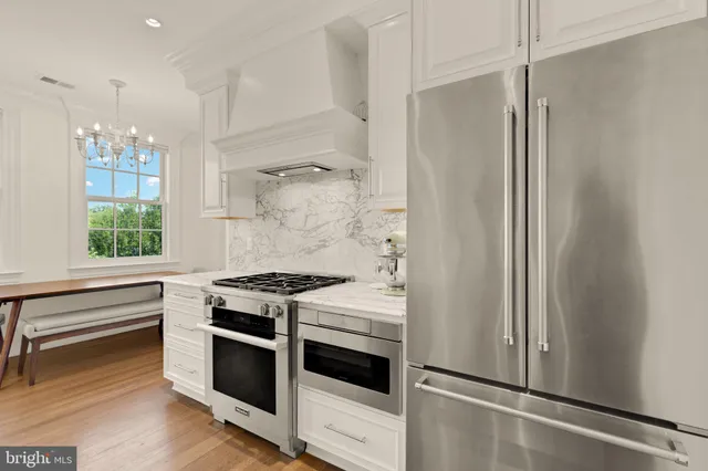a kitchen with stainless steel appliances a stove and a refrigerator