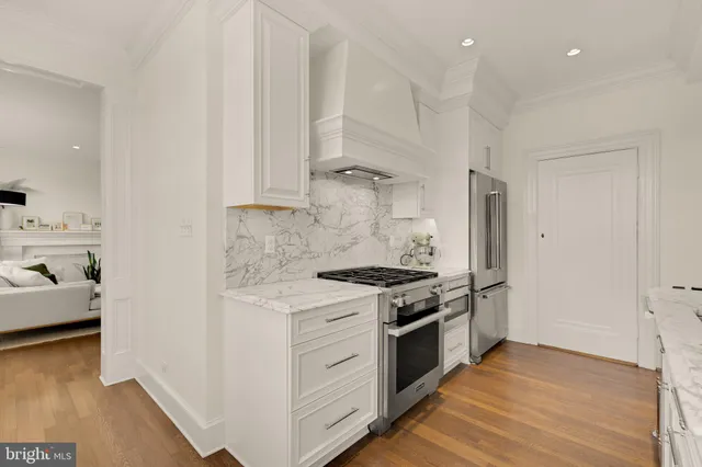 a kitchen with stainless steel appliances granite countertop a stove and a refrigerator