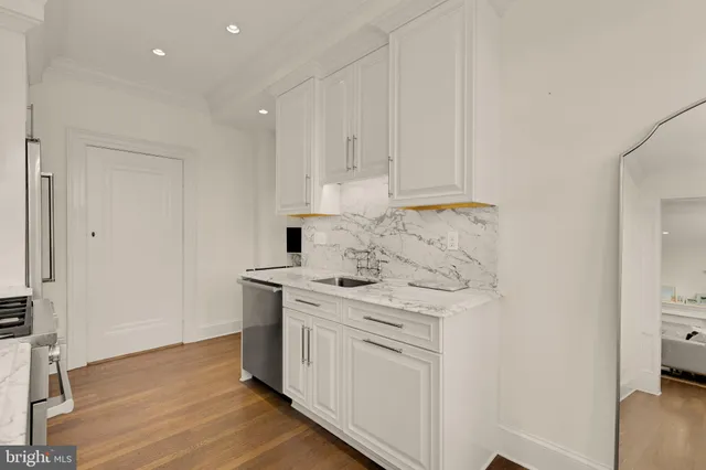 a kitchen with stainless steel appliances white cabinets and a stove