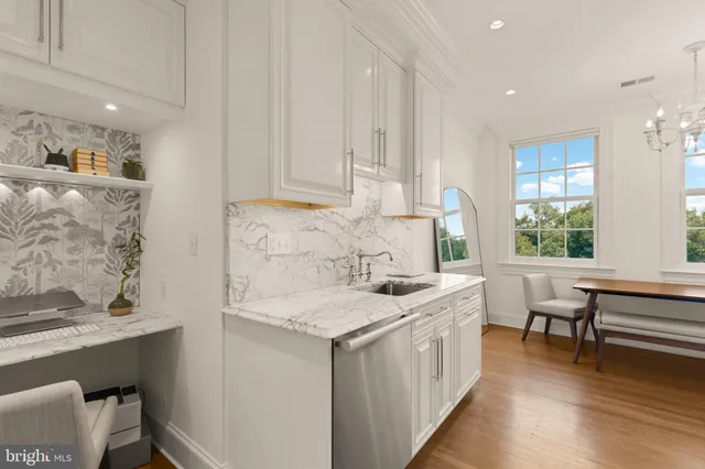 a kitchen with a sink stove and cabinets