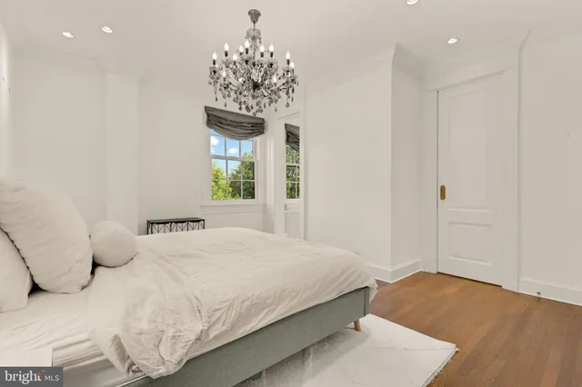 a bedroom with a bed and a chandelier