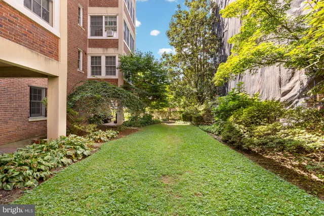 a yellow building with trees in front of it