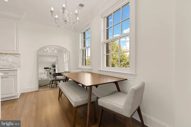 a view of a dining room with furniture window and wooden floor