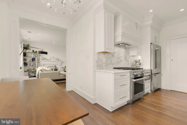 a kitchen with refrigerator and cabinets