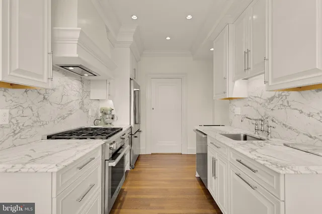 a kitchen with stainless steel appliances granite countertop a stove and a sink