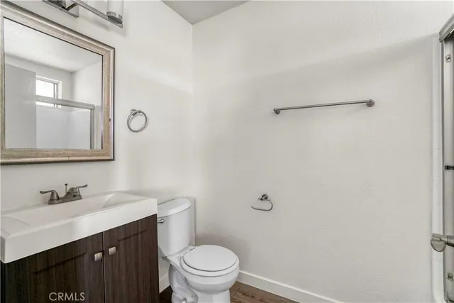 a bathroom with a sink vanity mirror and toilet