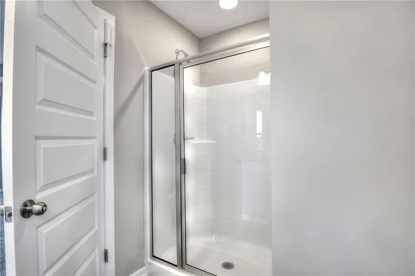 a bathroom with a glass shower door