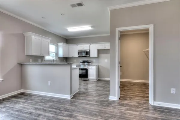 a kitchen with granite countertop a refrigerator and a stove