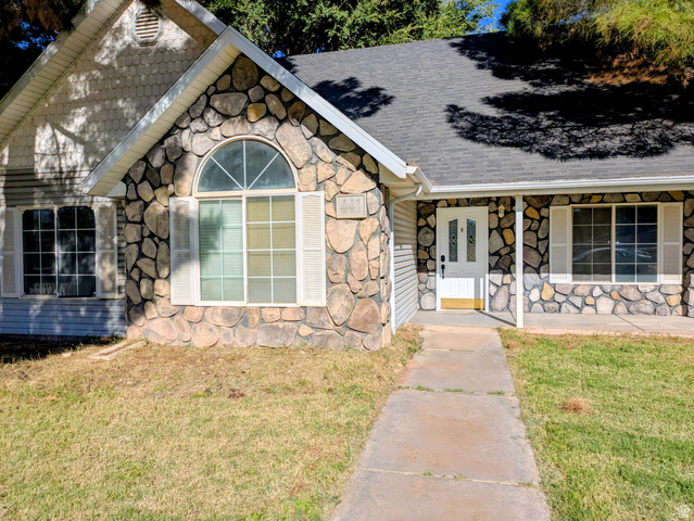 441 Main Street Hurricane, UT 84737 - Photo 5 of 29 Stone facade detailing with white framed windows and decorative shutters