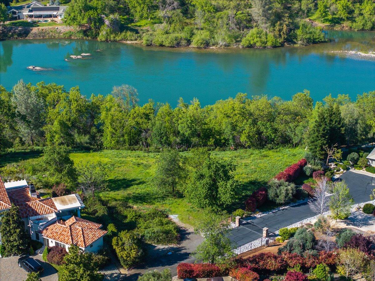 an aerial view of ocean residential house with outdoor space and trees all around