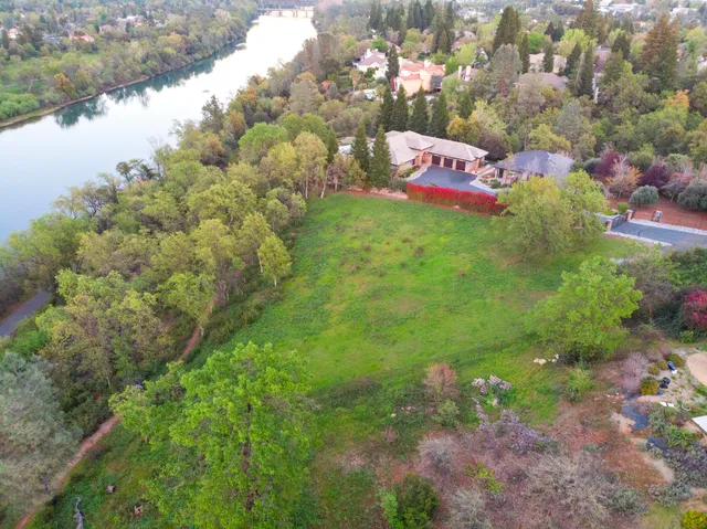 an aerial view of lake and residential houses with outdoor space