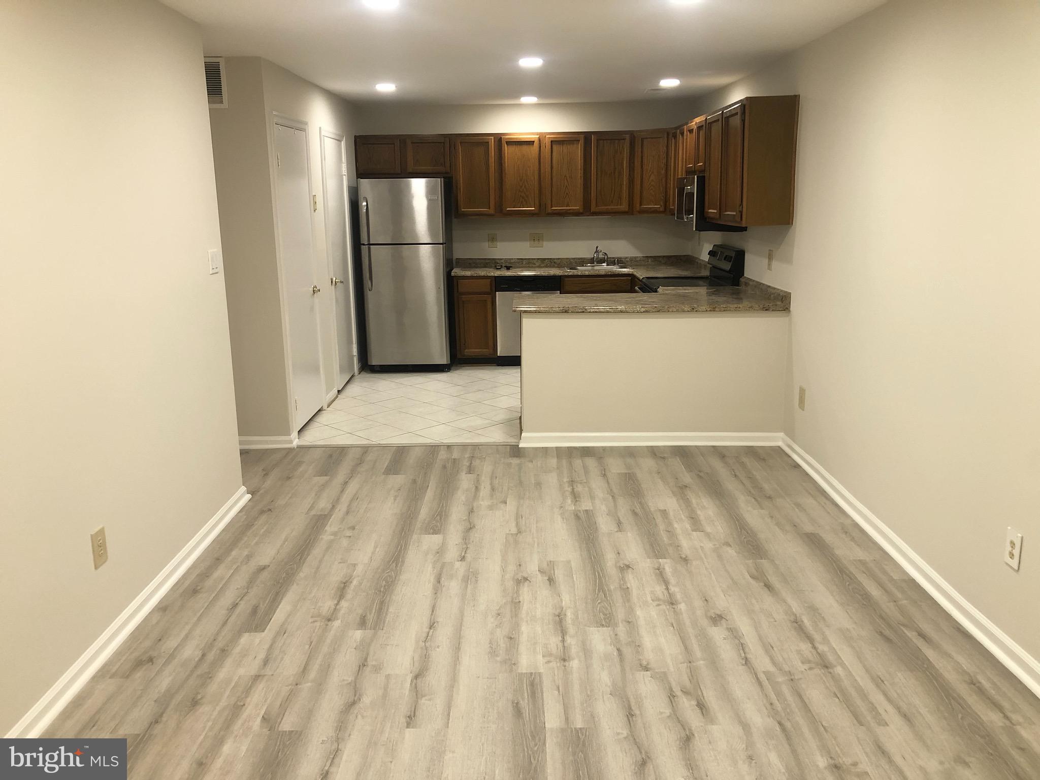 10700 Kings Riding Way, Unit T217 Rockville, MD 20852 - Photo 3 of 18 Living room Kitchen